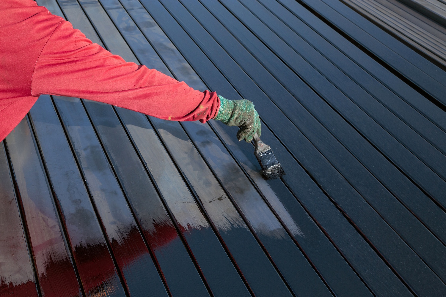 Workers are painting steel floors.